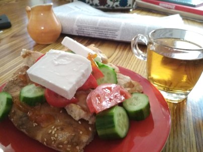 Typical Iranian breakfast - bread, feta, cucumber, tomato, chutney accompanied with tea